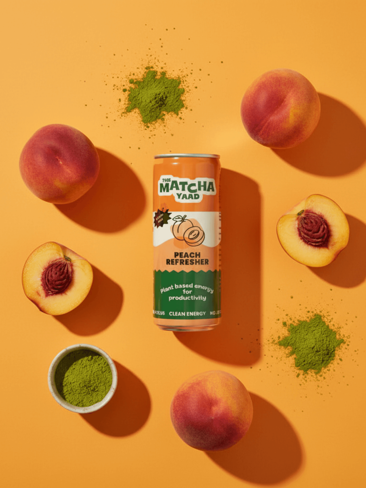 Peach Refresher matcha energy drink surrounded by fresh peaches and matcha powder on orange background, highlighting fruity and energizing ingredients.