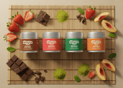 The Complete Matcha Collection with chocolate, strawberry, ceremonial, and peach matcha tins surrounded by fresh fruit and matcha powder on a bamboo mat.