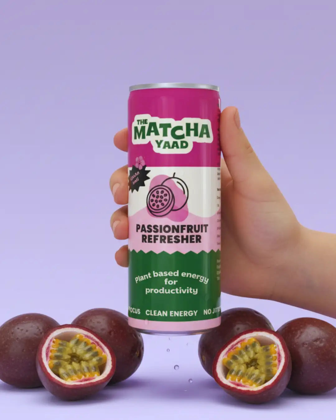 A vibrant pink and green can of the matcha yaad passionfruit refresher, featuring a playful design with illustrations of passionfruits.